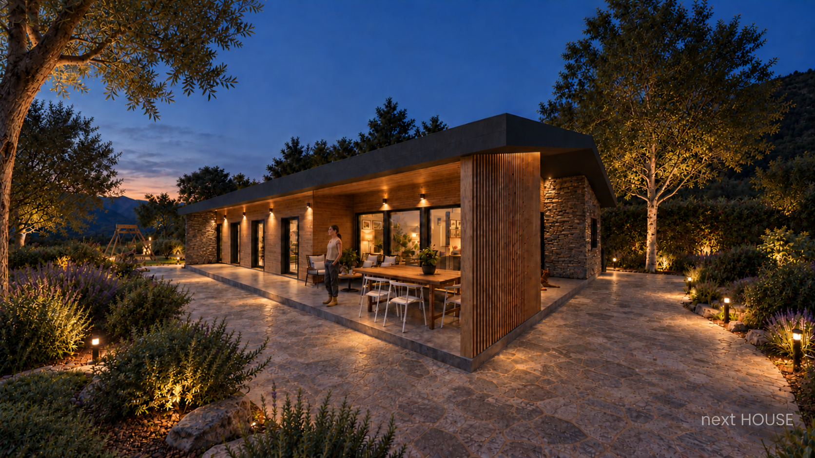 Casa Next House contemporánea de madera y piedra iluminada al anochecer